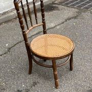 Vintage 19th-century bistro chair made of curved solid wood and caned in the Thonet style.