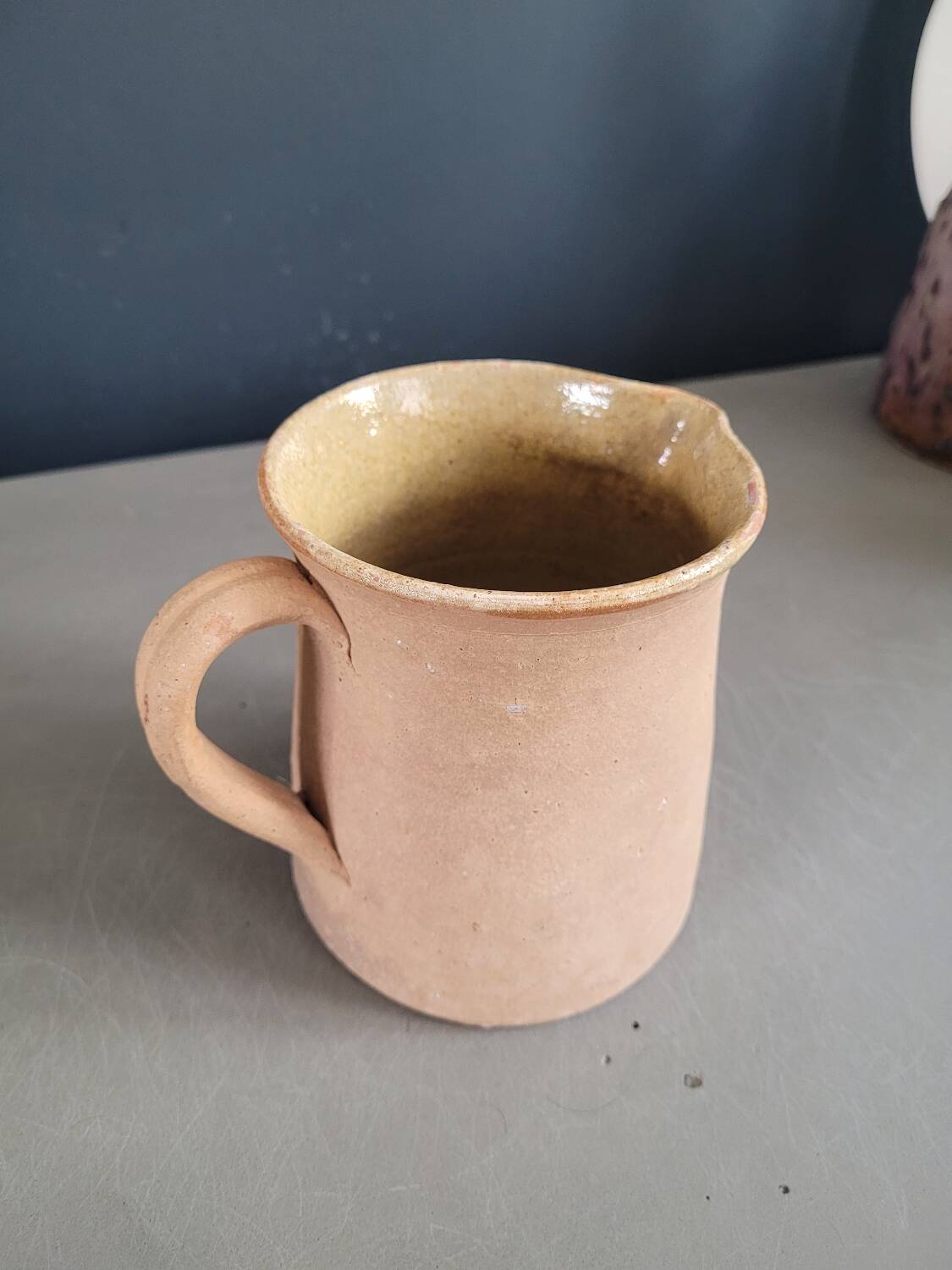 Antique milk jug in glazed terracotta
