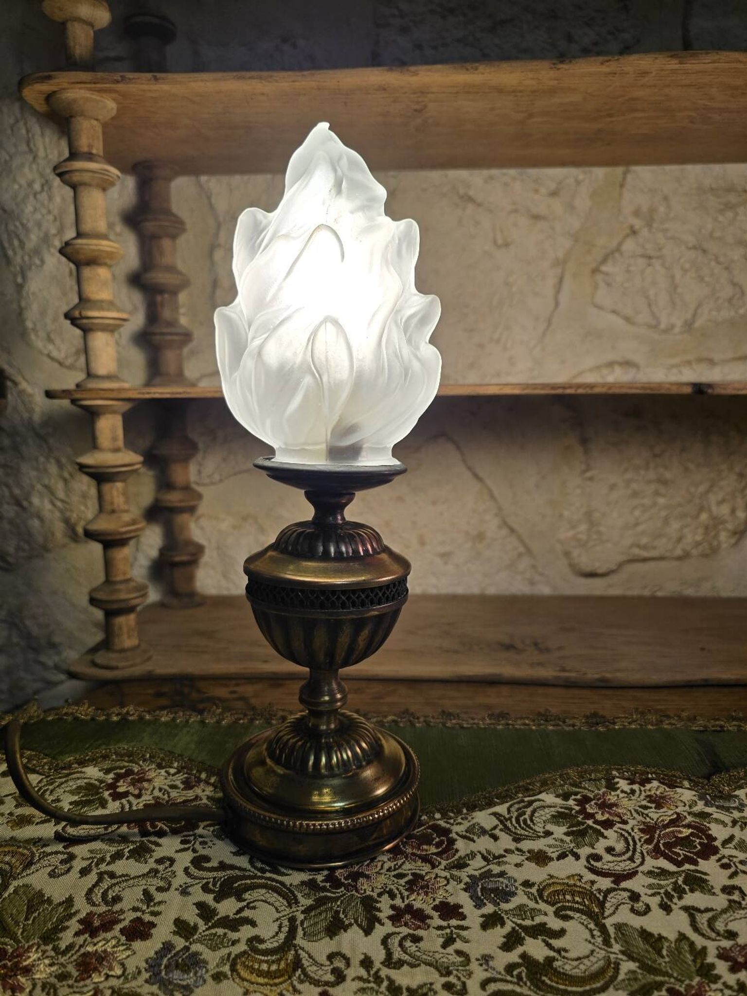 Small globe lamp with flame and brass base for oil.