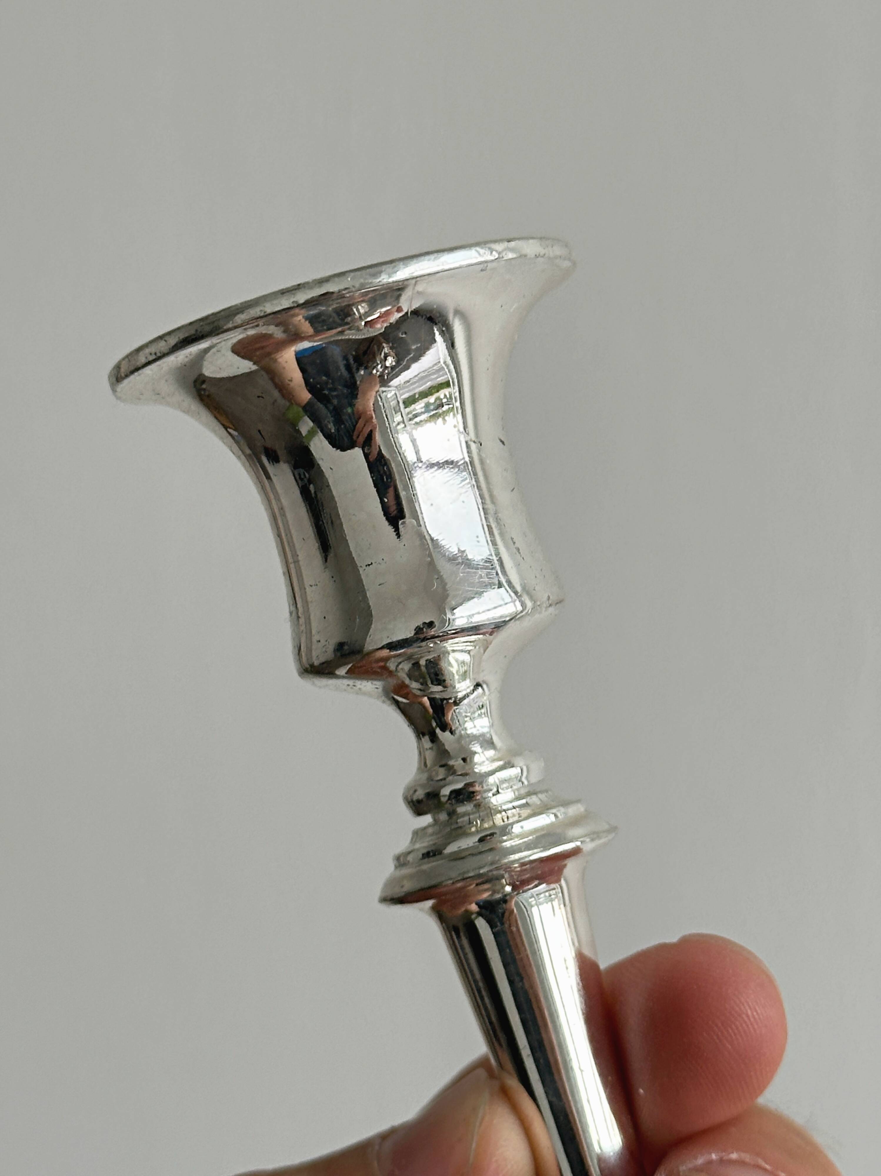 Pair of white metal candlesticks