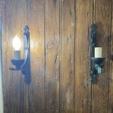 Two wrought iron wall lights, fabric cable.