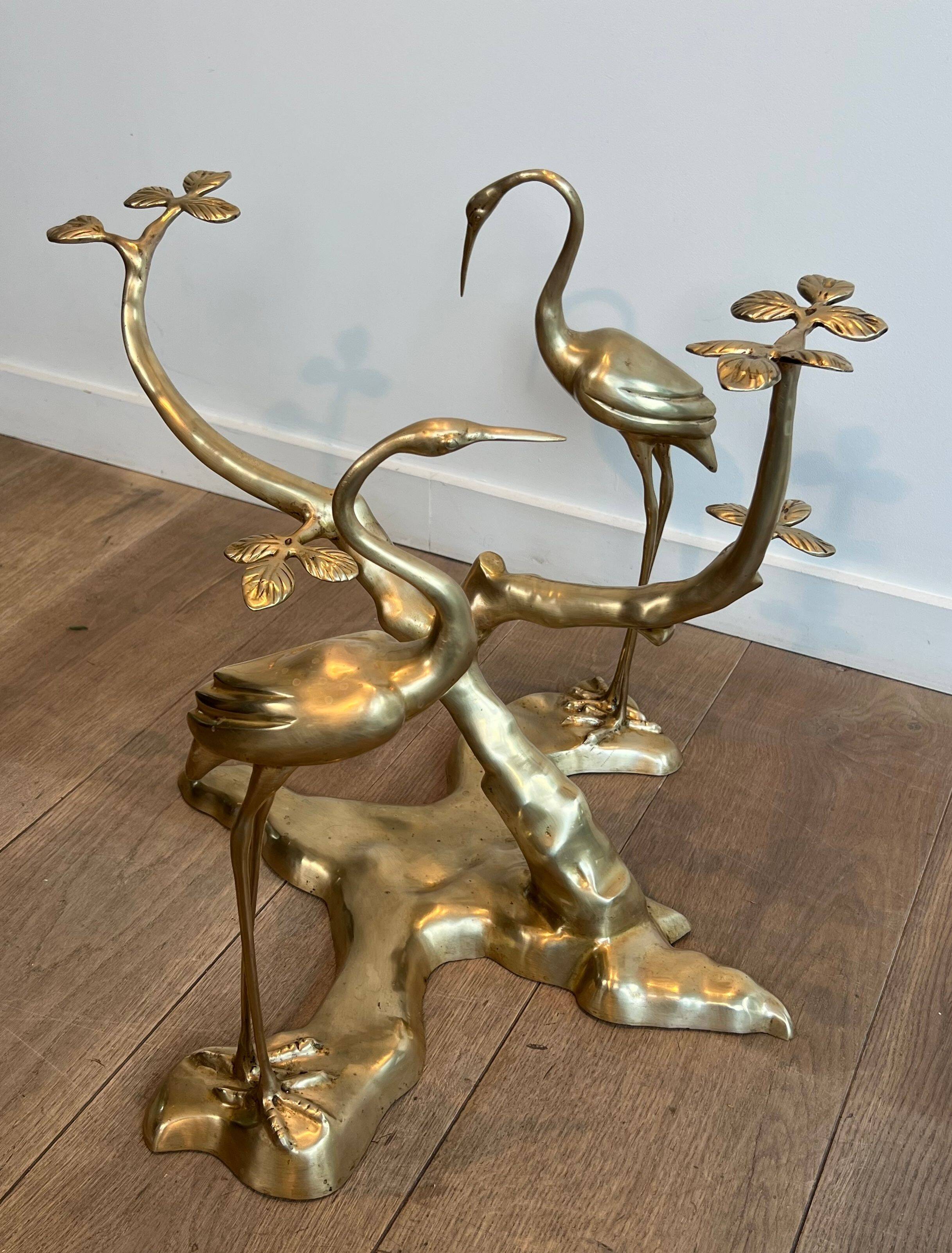 Coffee table model with cranes surrounding a brass bonsai and round glass top by Willy Daro.