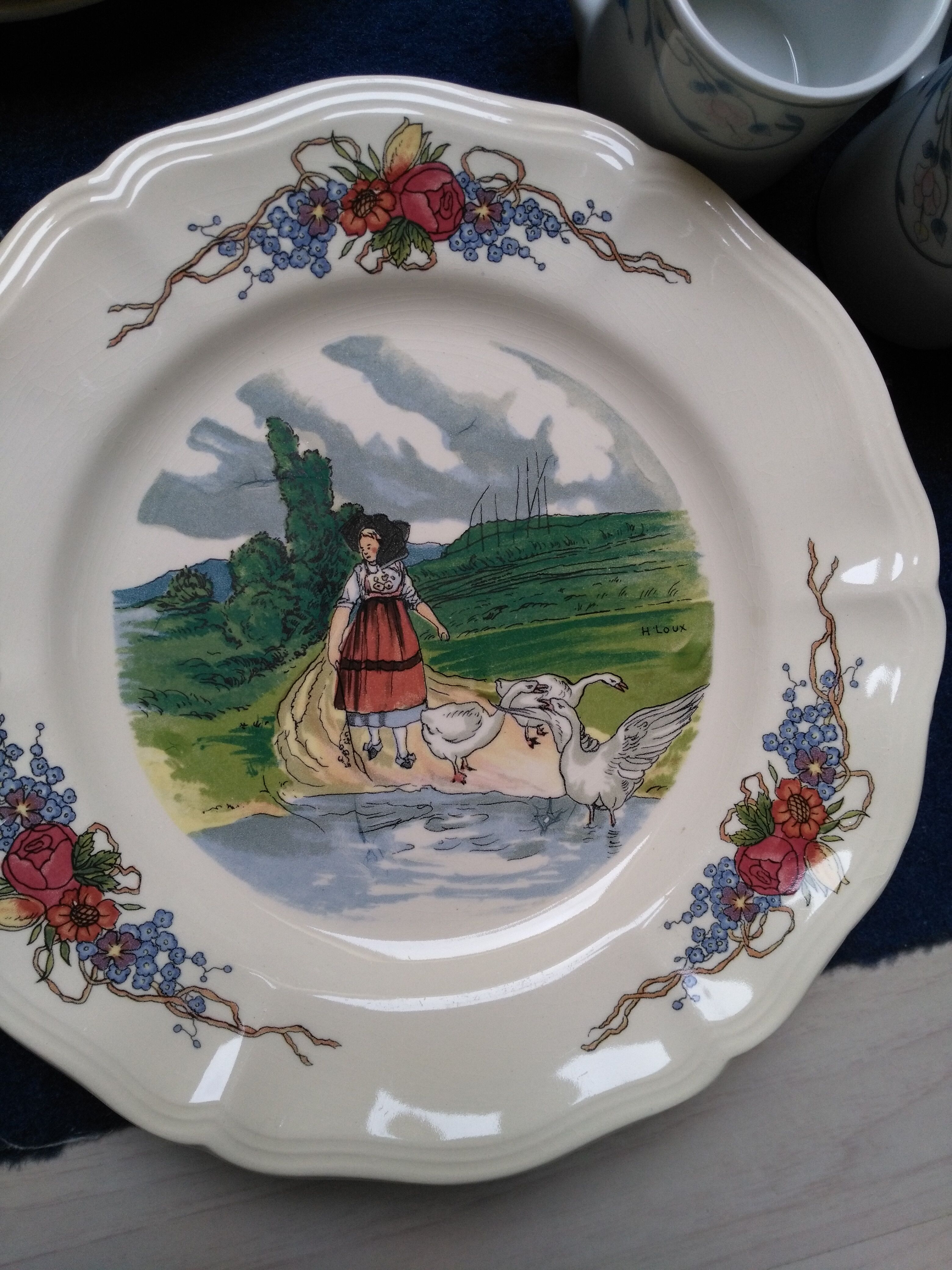 12 plates of the Obernai earthenware décor service signed Henri Loux