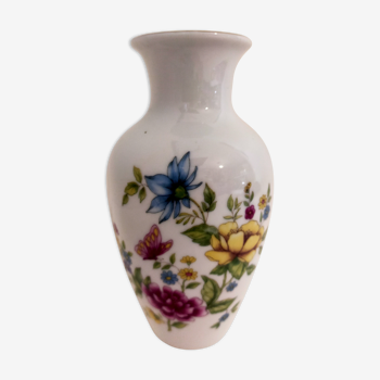 Small porcelain vase with flowers and butterfly