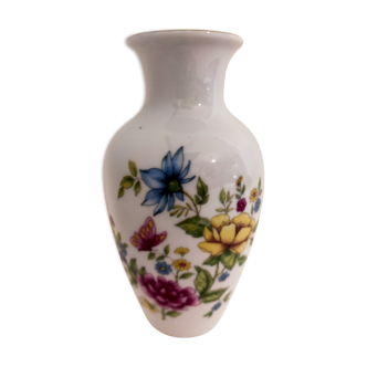 Small porcelain vase with flowers and butterfly