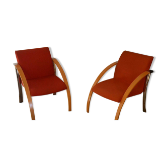 set of 2 low chairs, chrome legs, wooden armrests, seat and back in red fabric.