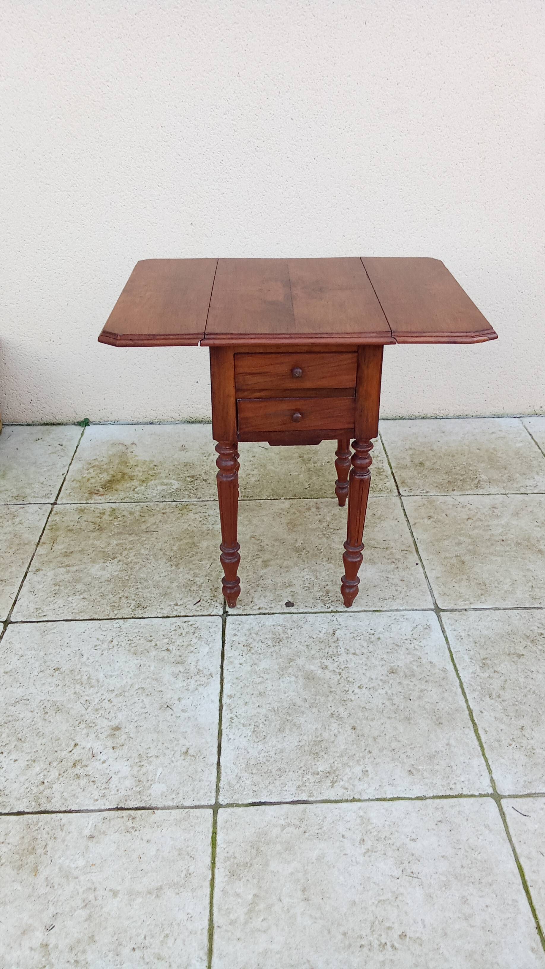 Antique small drop-leaf table from the 19th century.