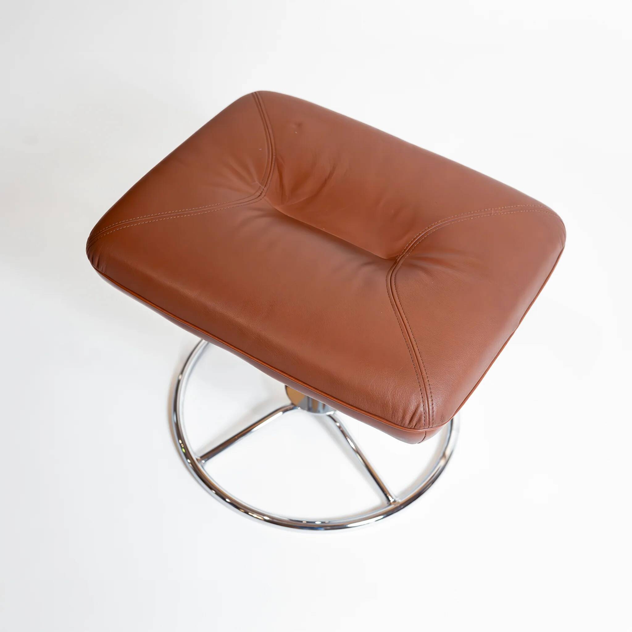 Vintage Scandinavian ottoman in brown leather with a chrome round base.