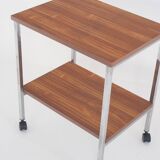 Vintage side table on wheels. Chrome-plated iron tube and wood. France, 1970s.