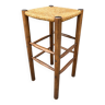 Old high bar stool in wood and straw