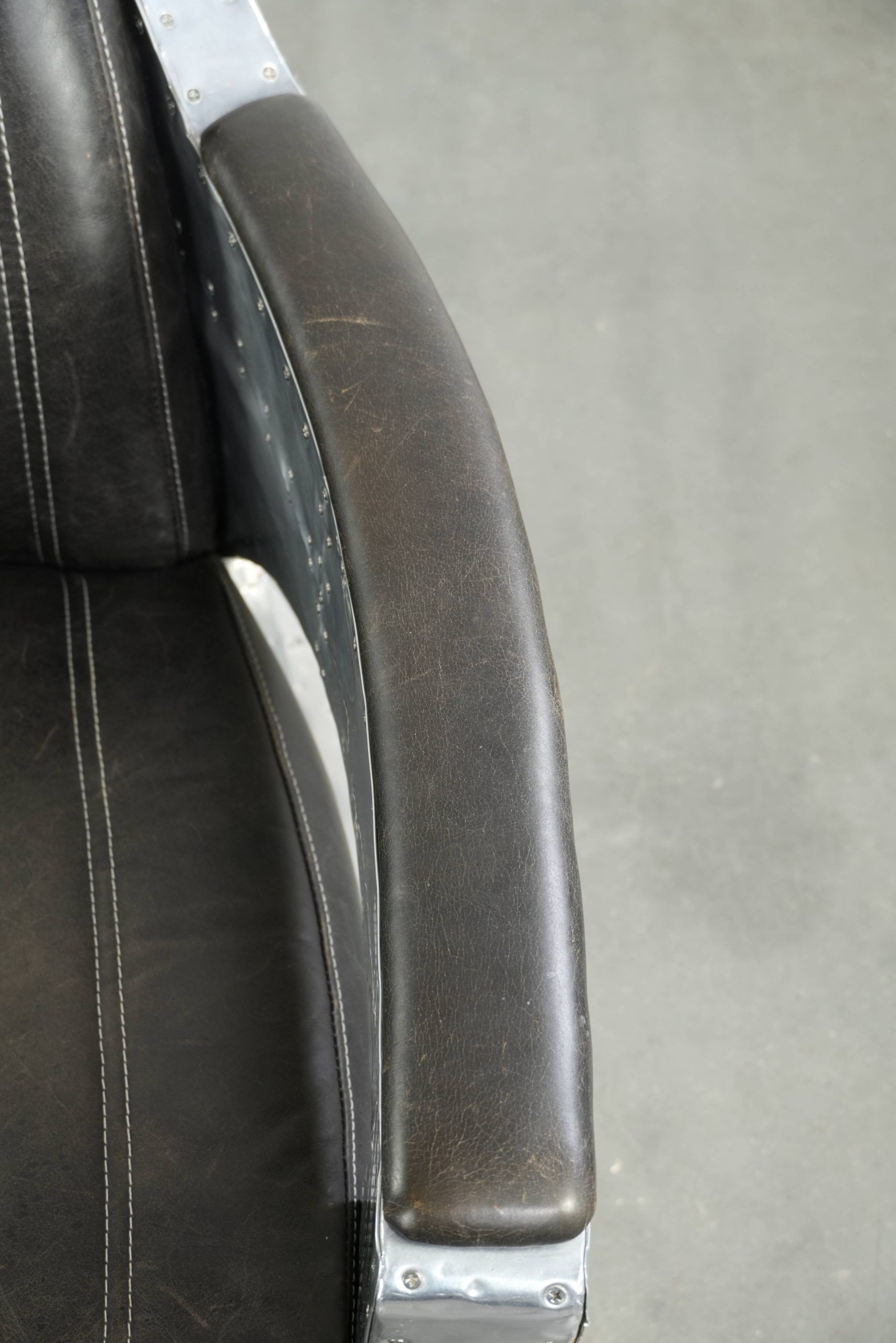 Cow leather aviator design armchair finished with aluminium and rivets