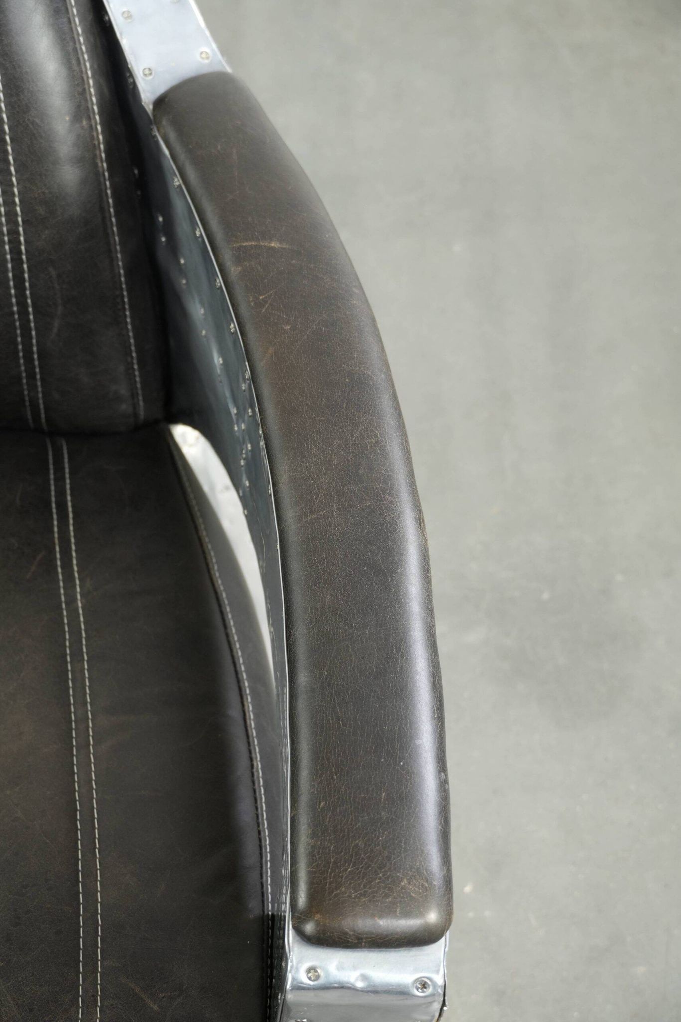 Cow leather aviator design armchair finished with aluminium and rivets