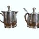 Two small silver-plated metal tea service pots from the 20th century.