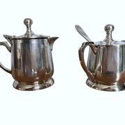 Two small silver-plated metal tea service pots from the 20th century.