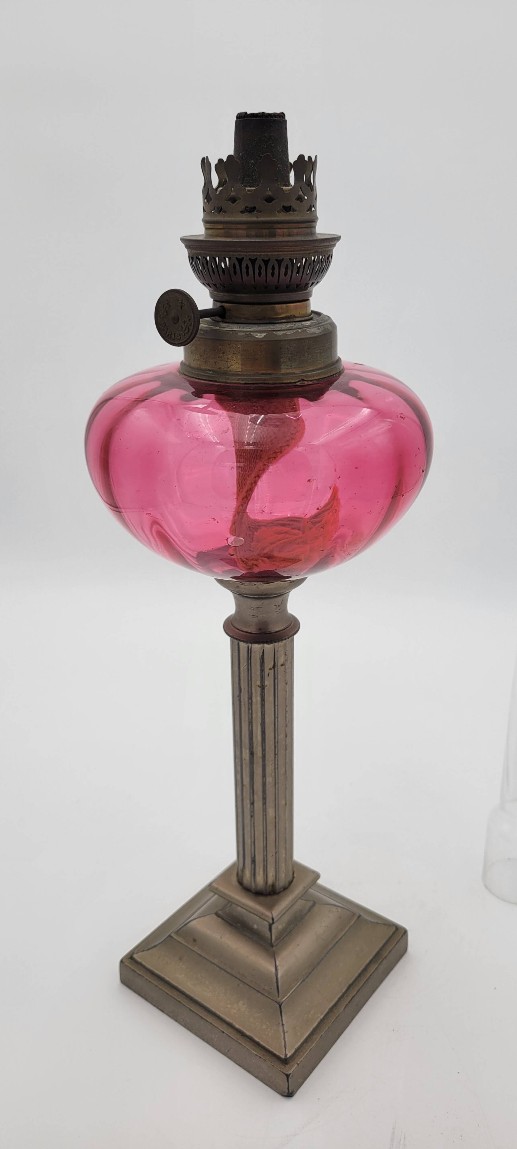 Old metal and pink glass oil lamp