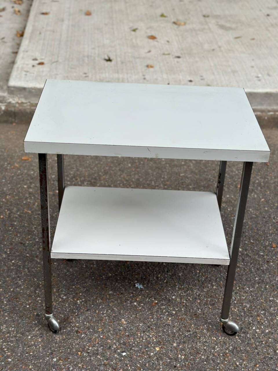 Rolling dessert trolley with 2 white formica shelves and steel, 1980.