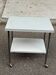 Rolling dessert trolley with 2 white formica shelves and steel, 1980.