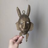 Handcrafted bronze wall mask, Sénoufo African art.