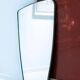 Contemporary rectangular mirror with rounded edges and embossed brass frame.