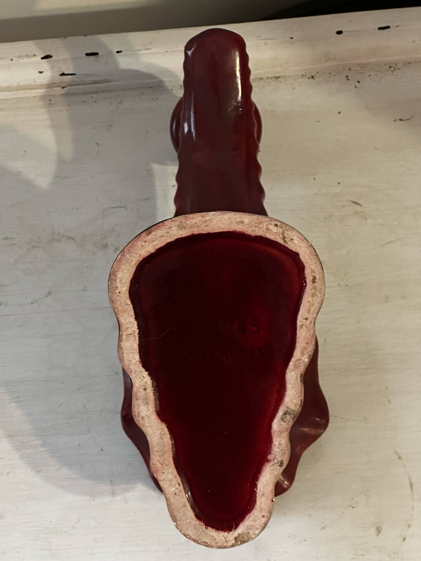 Ruby red ceramic pocket ashtray from Vallauris, numbered.