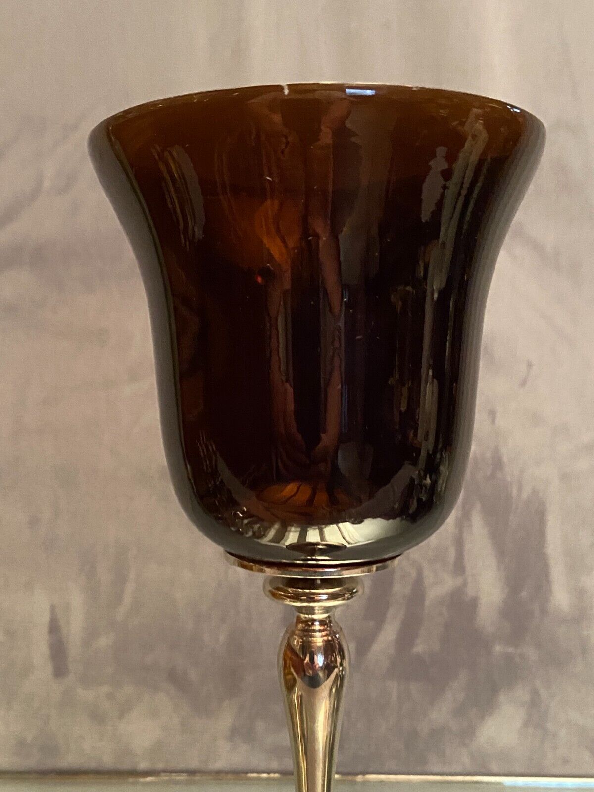 Tinted glass photophore on high metal foot with silver patina