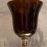 Tinted glass photophore on high metal foot with silver patina