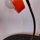 Orange metal lamp from the 60s and 70s.