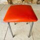 Vintage orange faux leather stool with chrome legs from the 1970s.