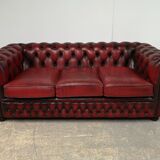 Three-seater red leather chesterfield sofa