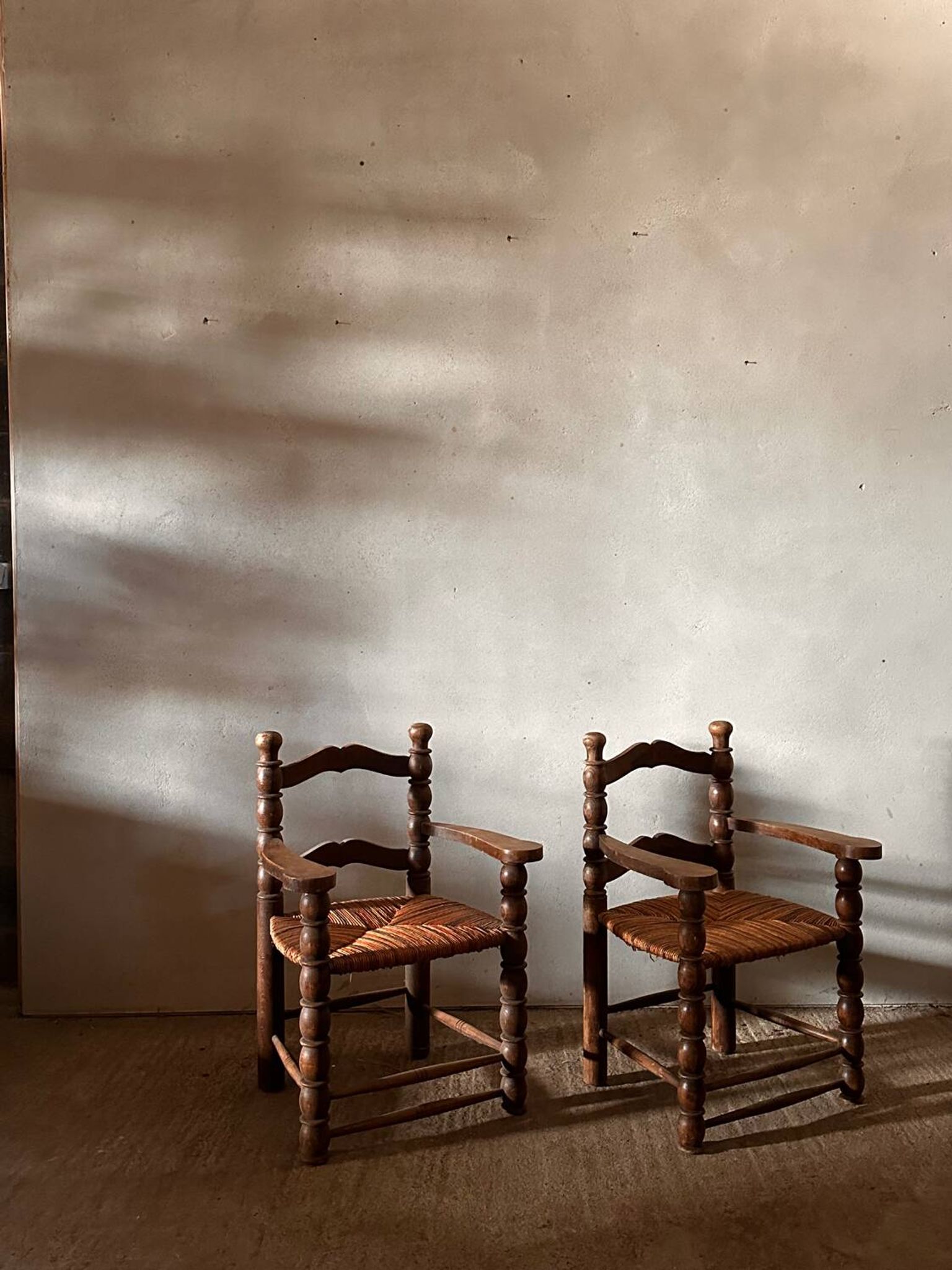 Pair of French spindle chairs in the style of Charles Dudouyt.