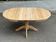 Round extendable dining table in raw solid wood, chic country style.
