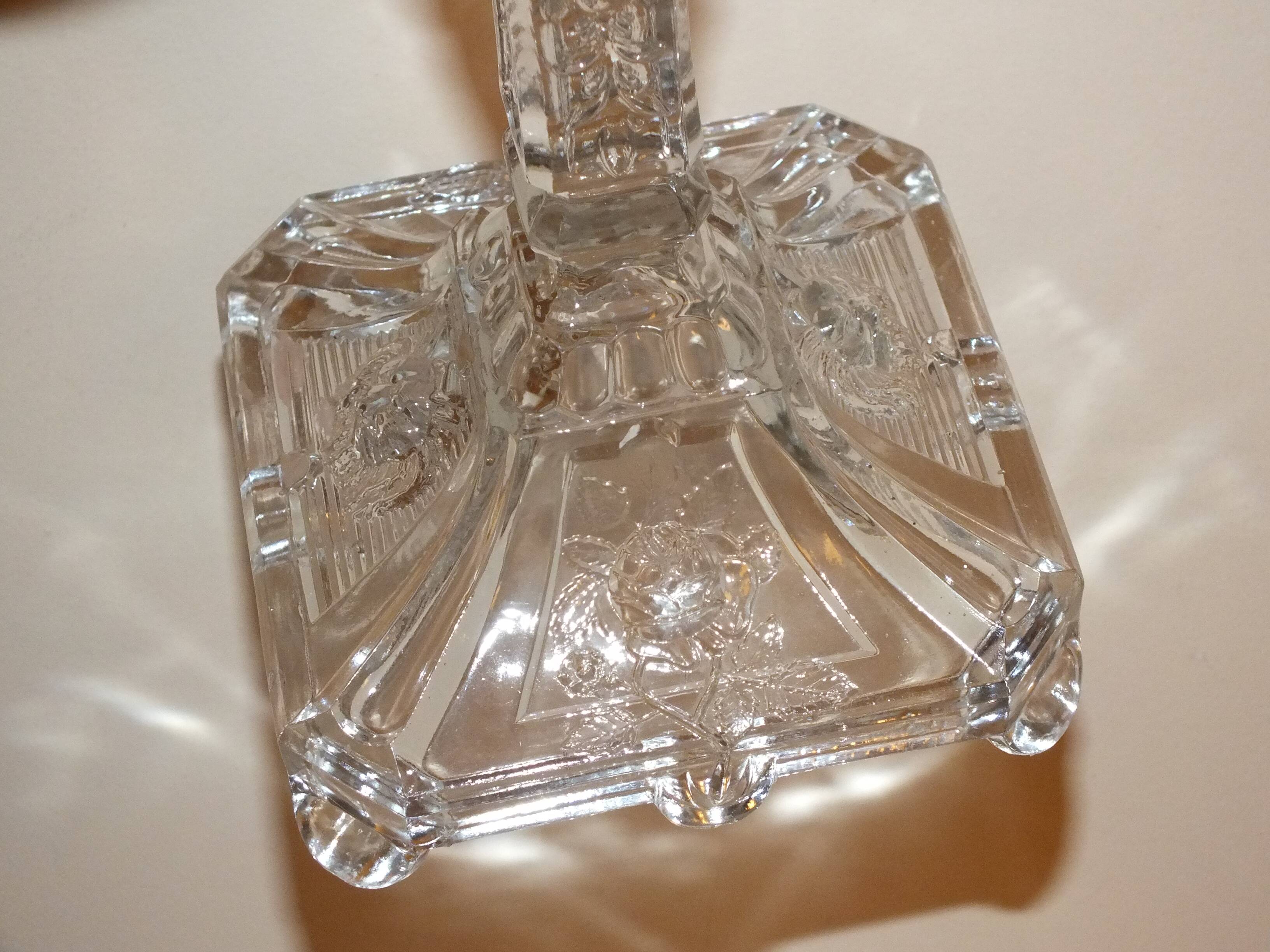 19th century candlestick in molded glass decorated with roses and lions