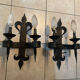 Pair of wrought iron wall lights in fleur-de-lis château style.