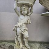 Antique reconstituted stone planter depicting a cherub