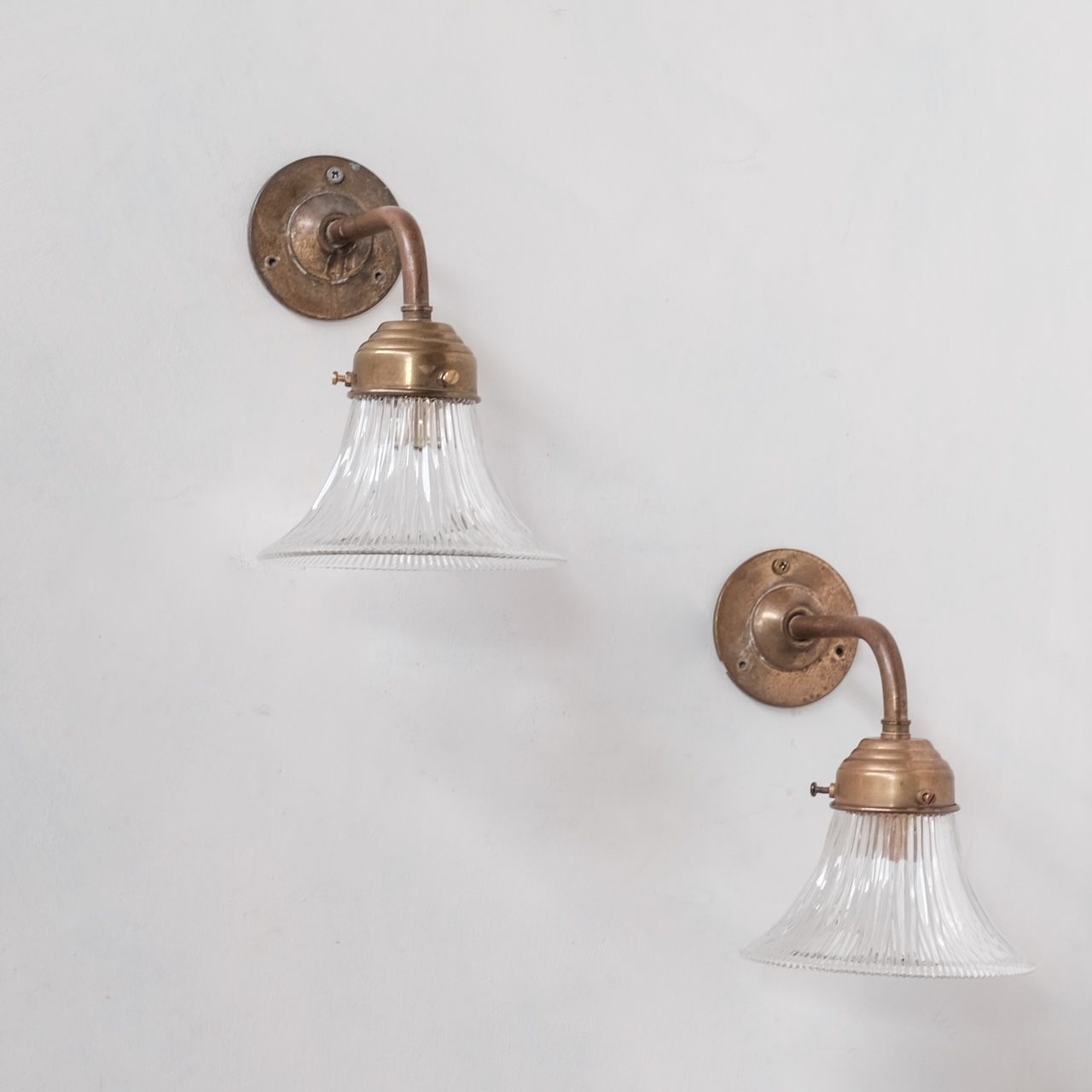 Pair of brass and holophane glass french mid-century wall lights