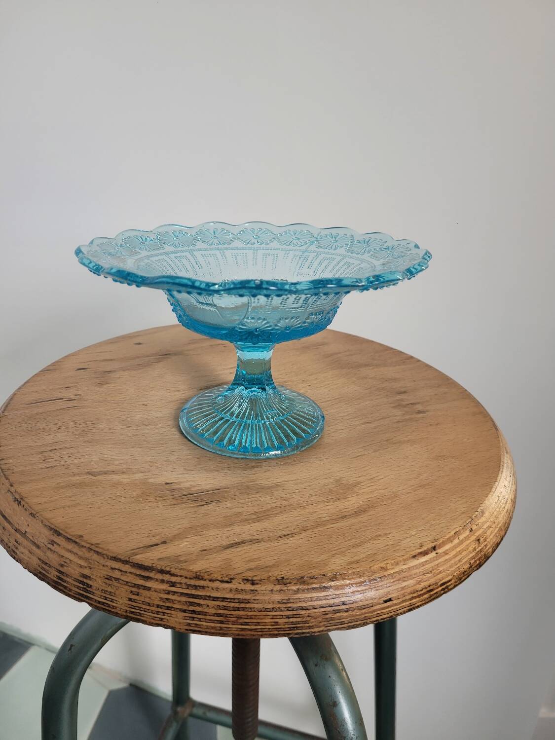 Plate on blue glass pedestal