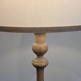 Vintage floor lamp in turned wood with aged effect.