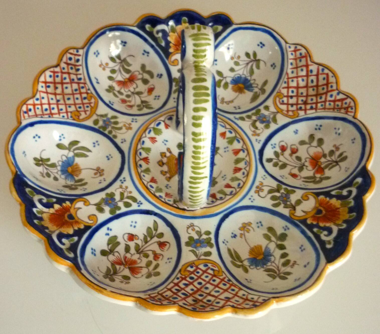 Dish, egg server in hand-painted earthenware, signed Geo Martel