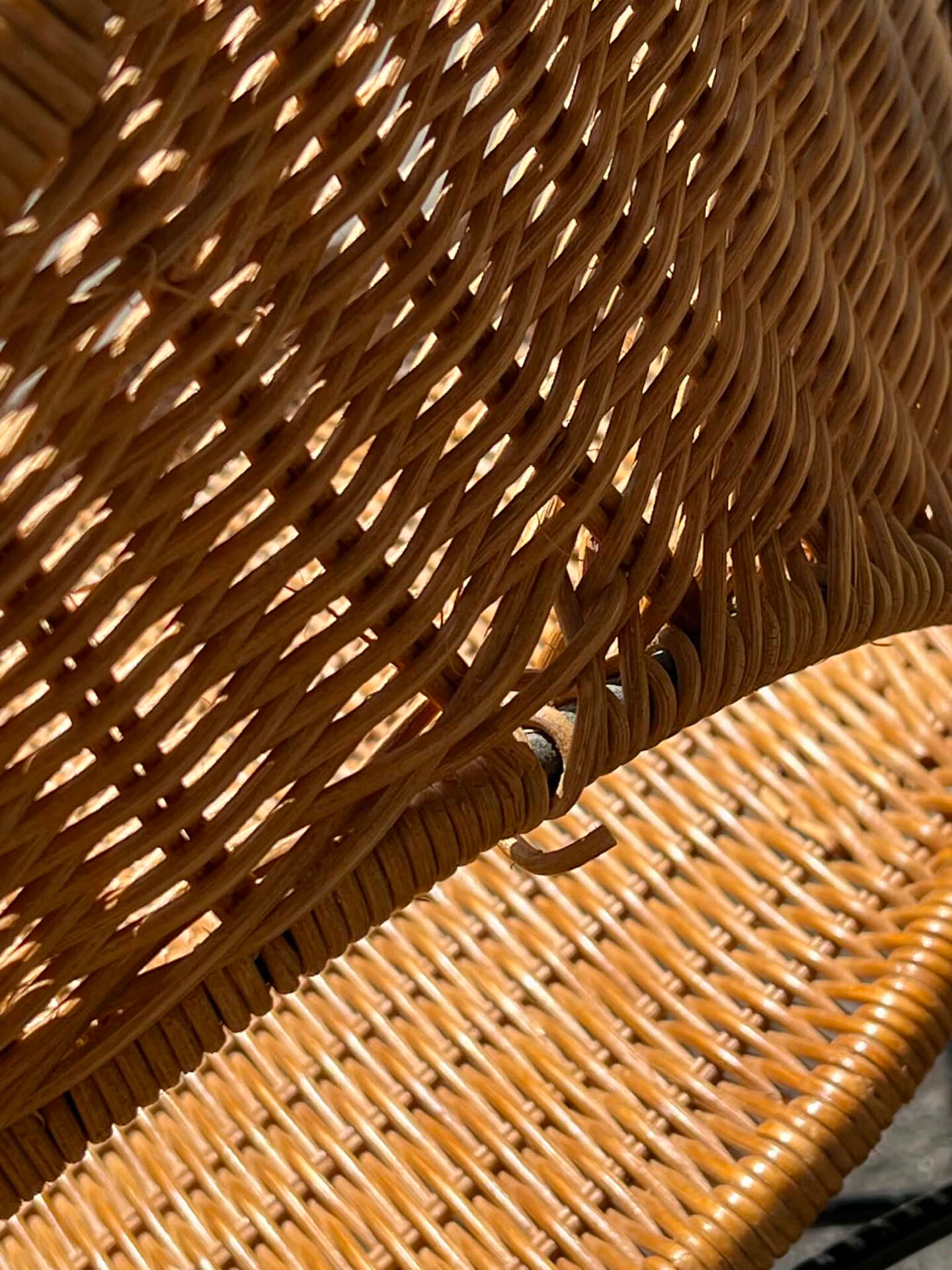 Wicker and black wrought iron armchair
