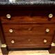 Empire chest of drawers with half columns in mahogany and gilded bronze