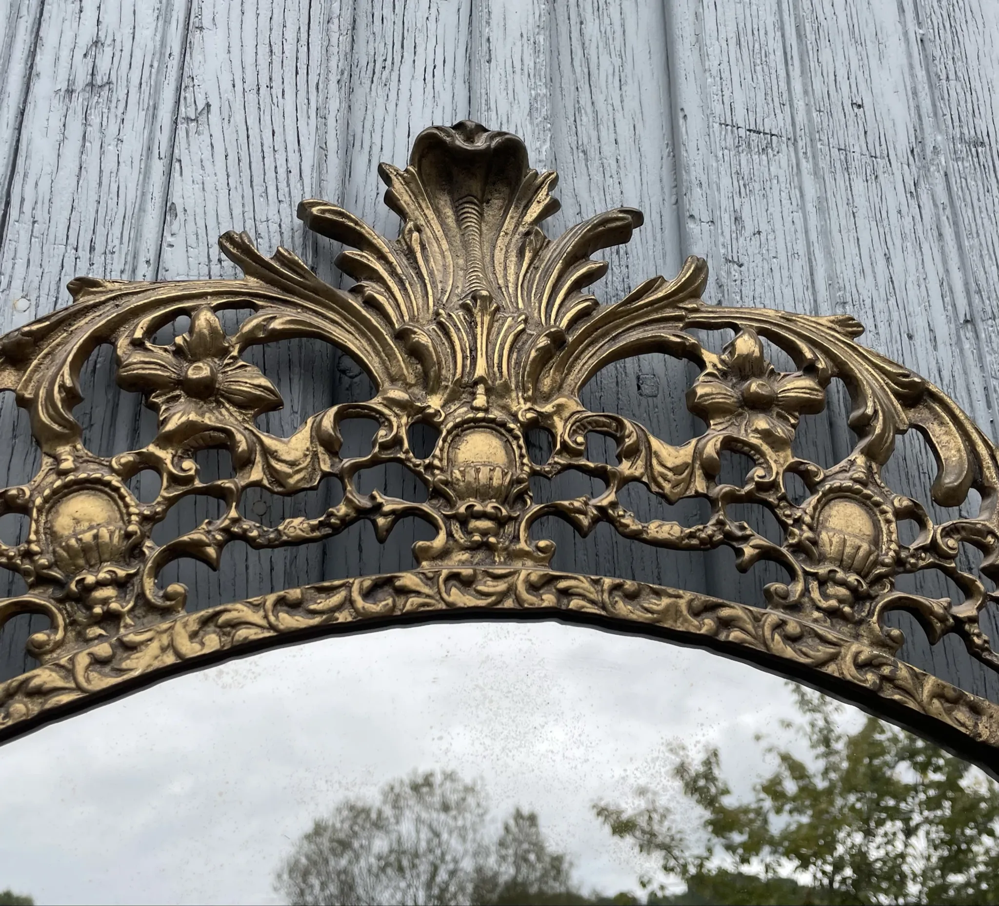 Vintage brass wall mirror adorned