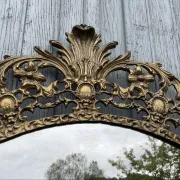 Vintage brass wall mirror adorned