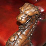 Victorian Chesterfield leather sofa with carved lion heads.