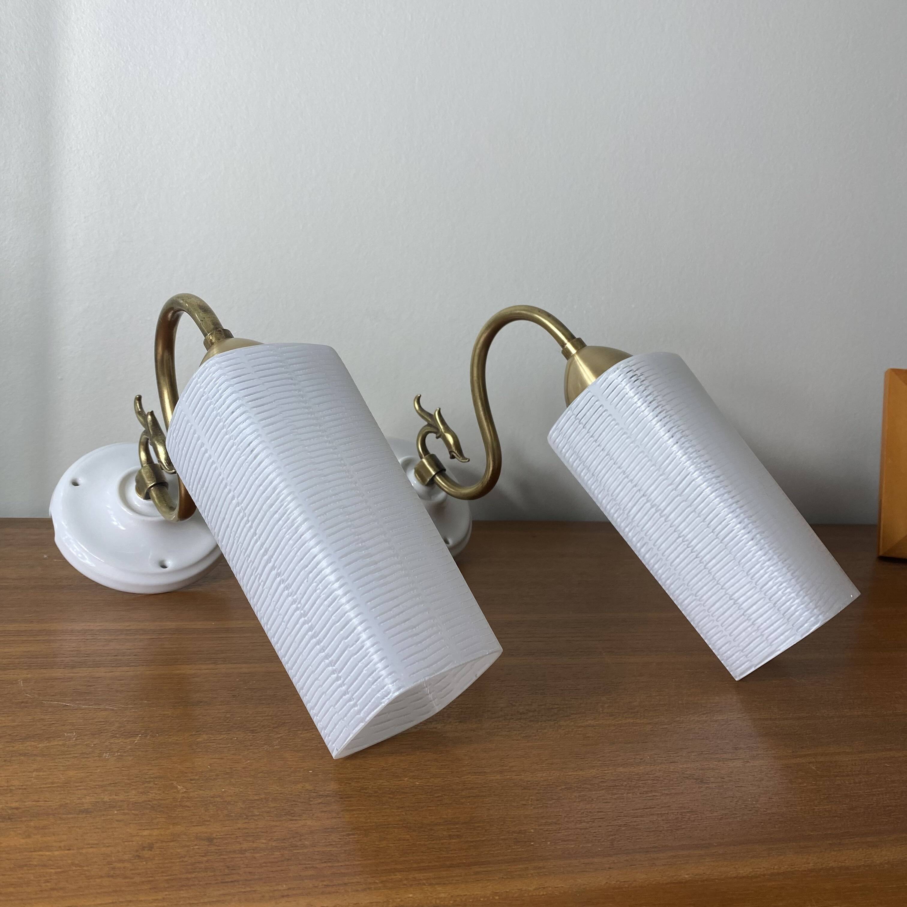 Pair of swan neck wall lights in brass, white glass and porcelain.