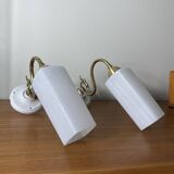 Pair of swan neck wall lights in brass, white glass and porcelain.