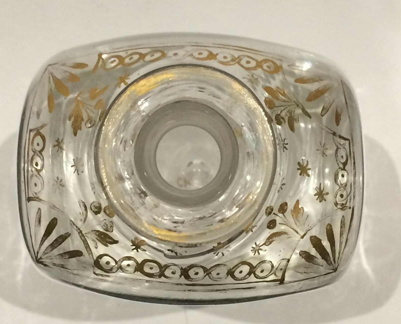 Glass bottle decorated with gold motifs