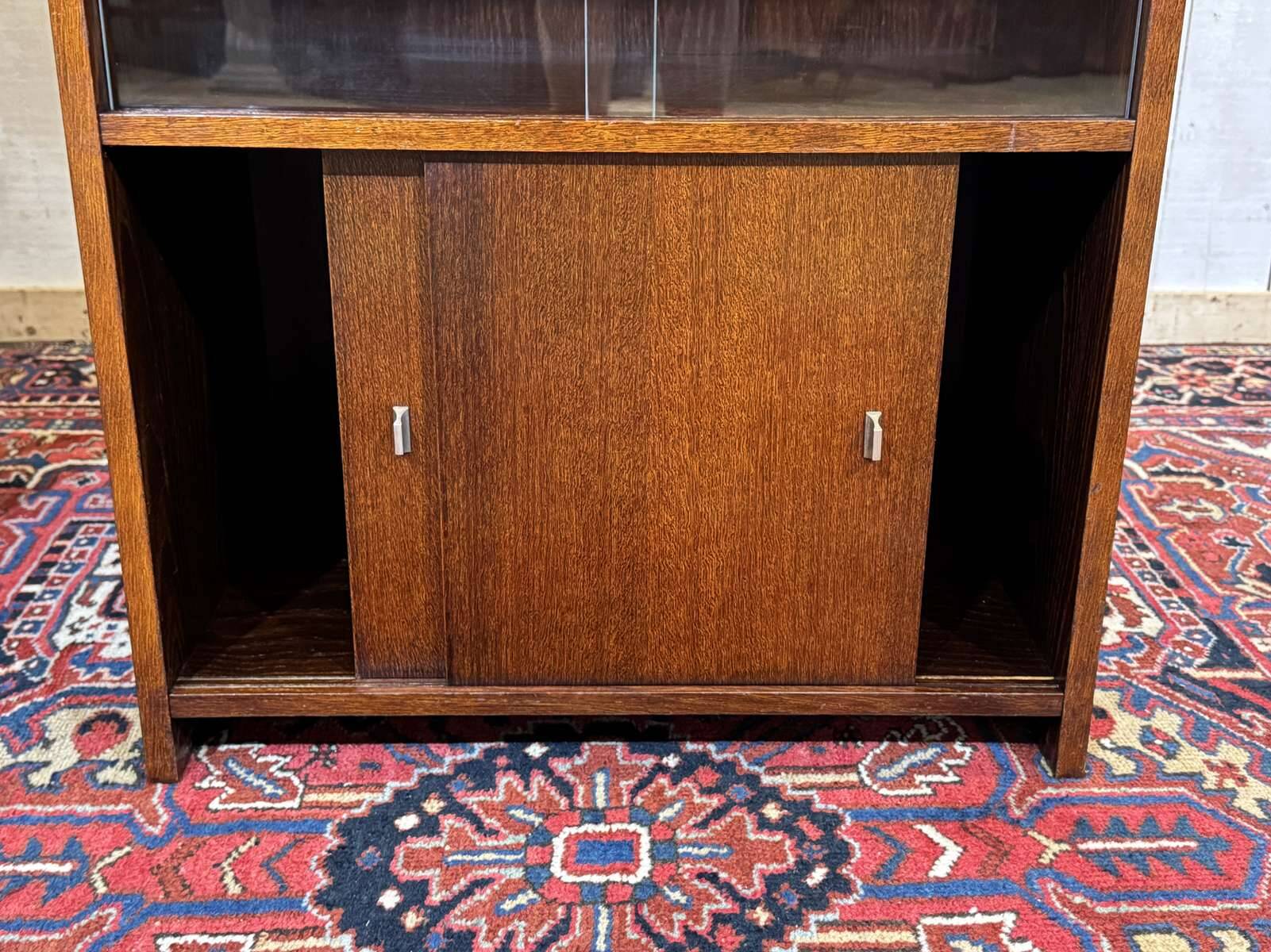 Small English oak library from the 1960s with sliding doors.