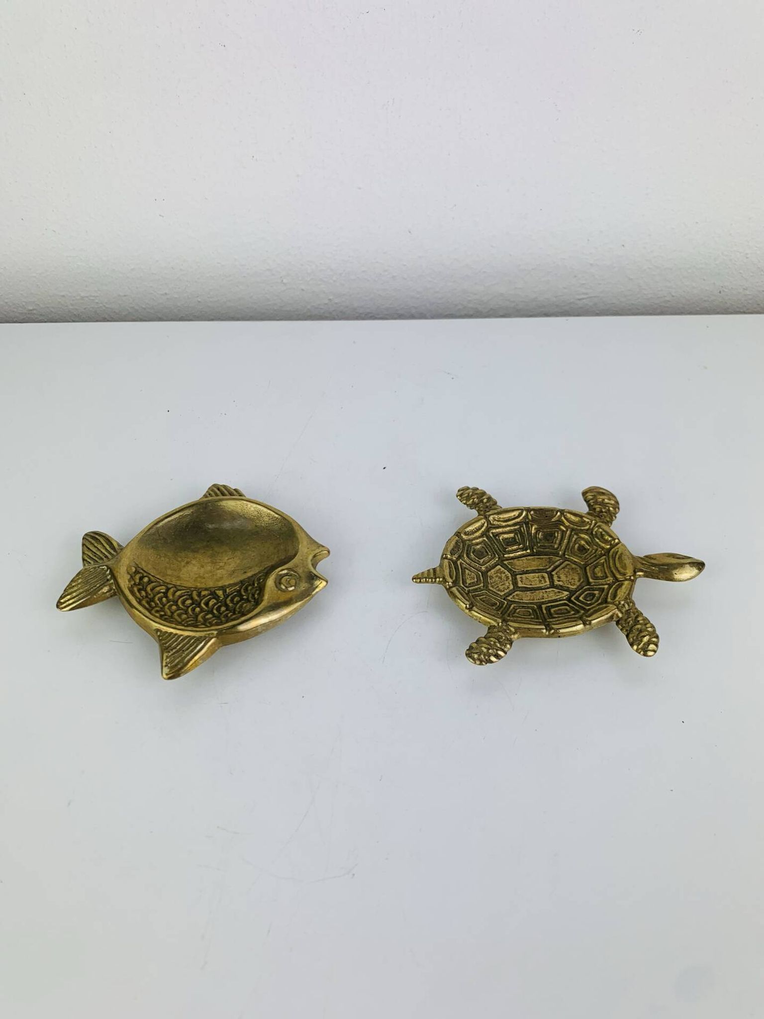 Pair of animal trinket trays in brass, fish and turtle.