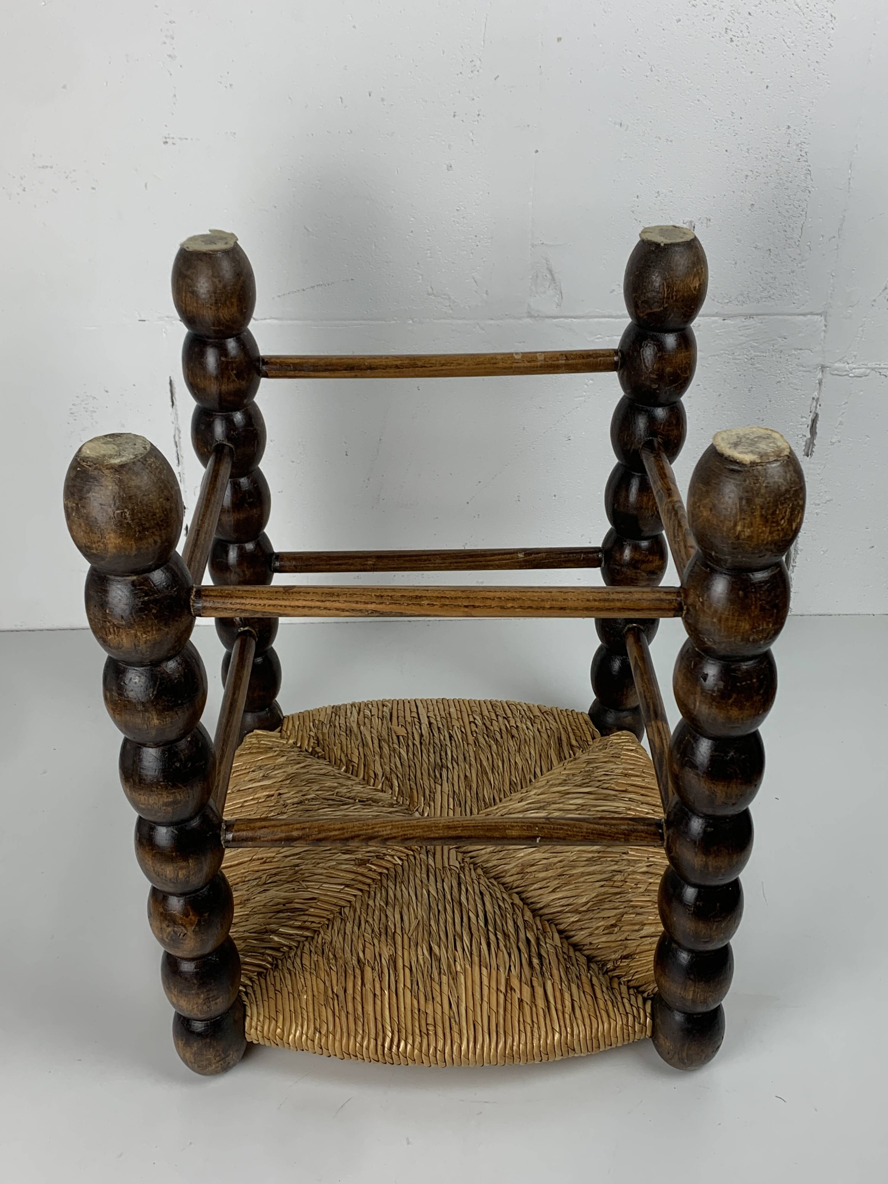 Brutalist wood turned bobbin rush stool in the style of Charles Dudouyt