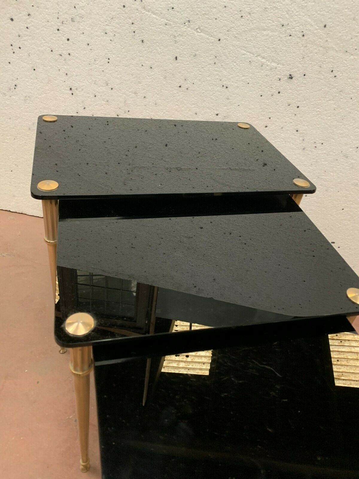 Pull out tables in brass and black glass XX century